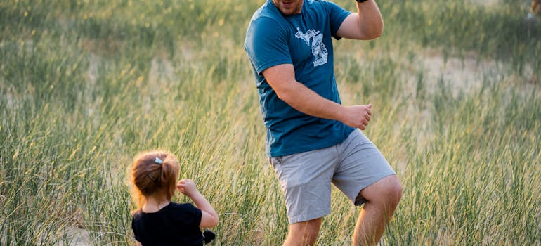 a dad playing with his kid and telling hr that embrun is ideal place to raise a family