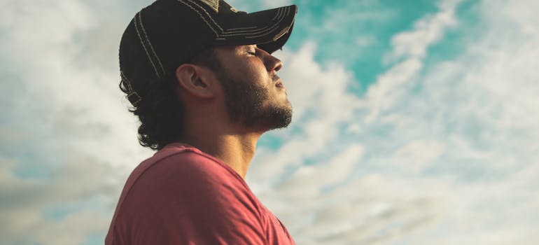 Man wearing black cap with eyes closed