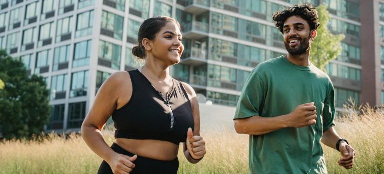 Couple jogging together, buildings in the background