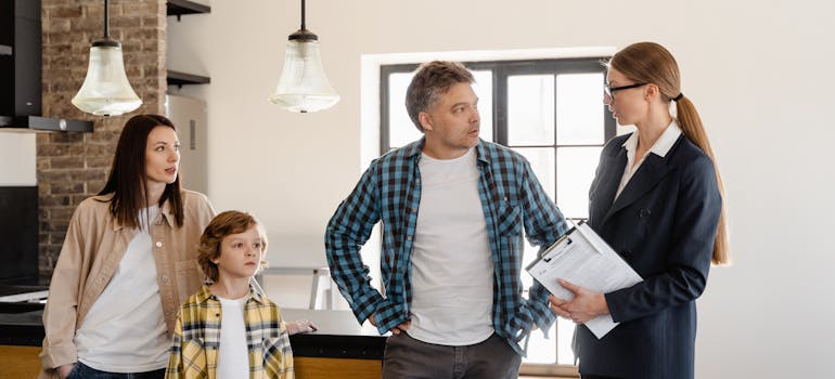A family talking to a real estate agent about the pros and cons of moving to Barrhaven