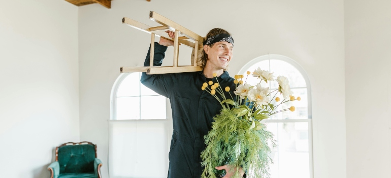 a man holding a chair