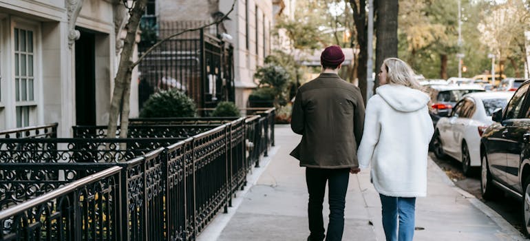 a couple walking down the residential city area