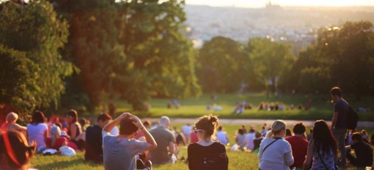 a lot of millennials sitting on the grass