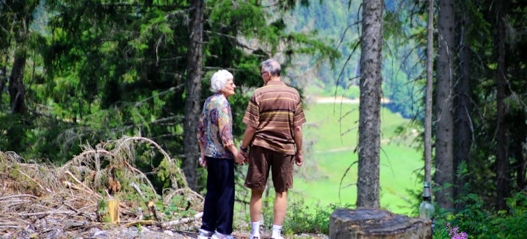 senior couple walking in the woods