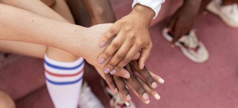 Diverse group of people putting hands together