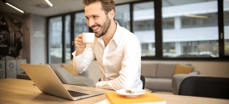 a man in white sitting in office and working as financial officer, one of the highest paying job in Ottawa
