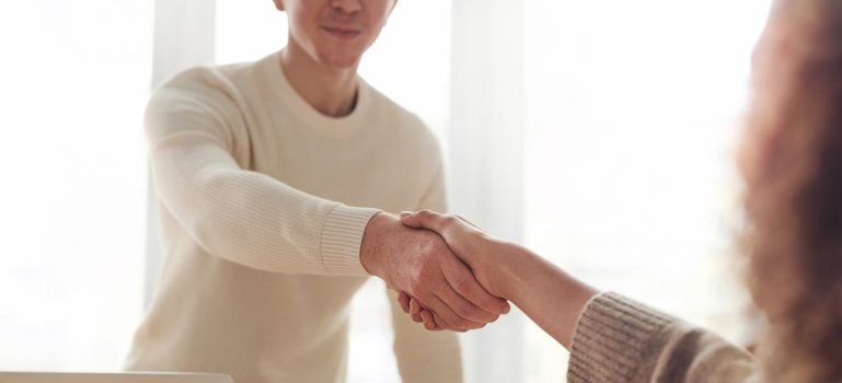 a man shaking his hand with a woman