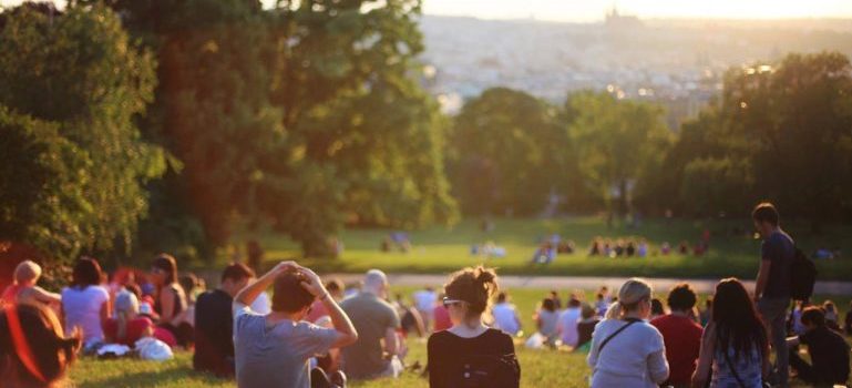 a group of people sitting on the grass