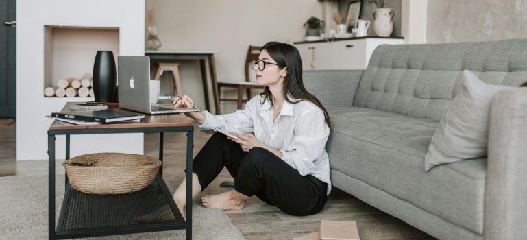 Woman sitting on the floor and using her laptop
