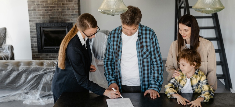 a family talking to a real estate agent