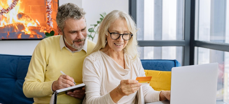 an old couple looking at a laptop