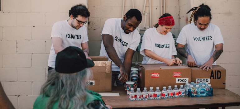 Volunteers distribute food boxes.