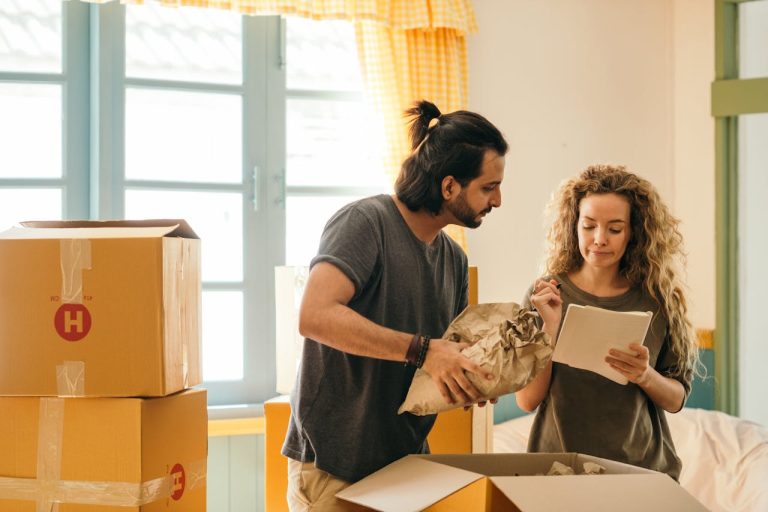 Happy couple unpacking boxes in new home after moving from Carleton Place to Toronto