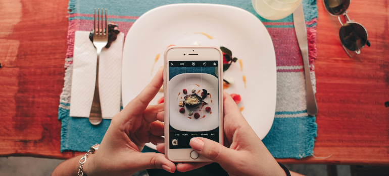 man taking photo of food