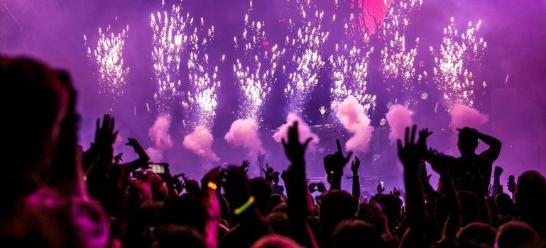 Big crowd at a concert, lights and sparkles around