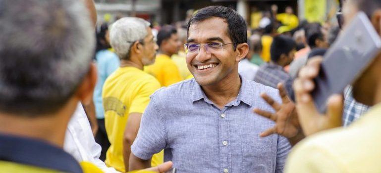 Man talking to people and smiling