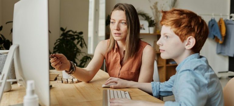 Mother and son using computer to explore ways to prepare kids for school after moving to Ottawa