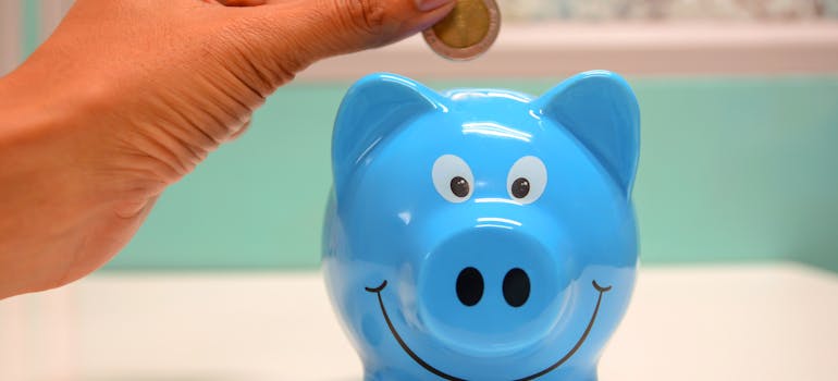 Putting coin in a piggy bank