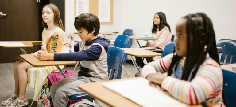 A group of students sitting at desks in a classroom
