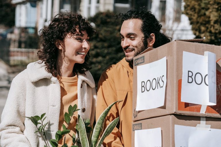 a couple holding boxes after reading about Moving out of your parents' house in Mississippi Mills