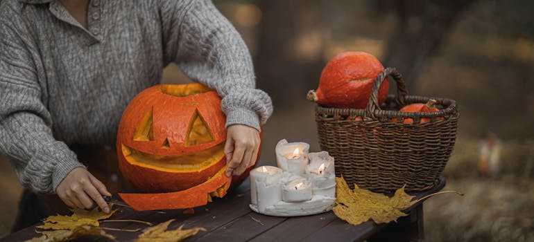 A woman carving a pumpkin