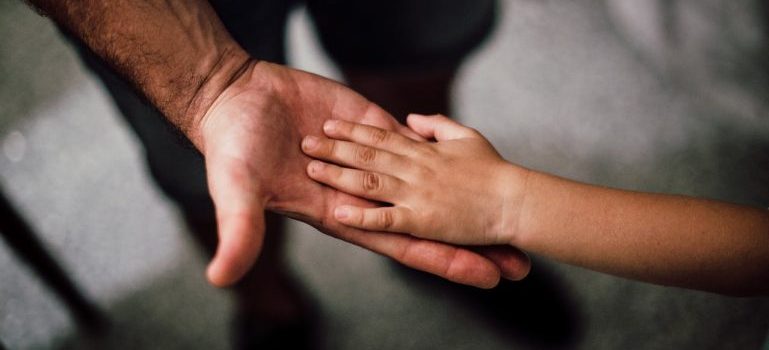 father and child hands together