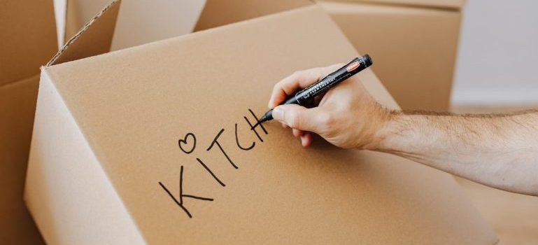 person writing on a box