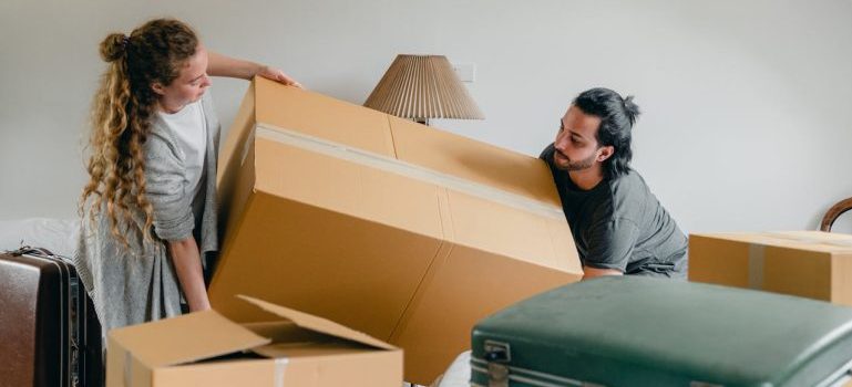 a couple holding big box