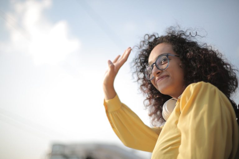 woman in yellow blouse waving and moving out of your parents house in Perth ON