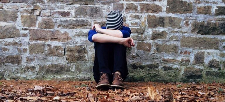boy sitting on ground 