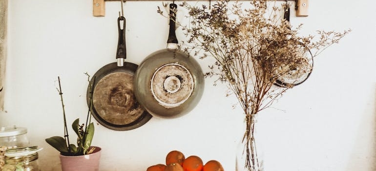 Pans hanging on hooks in the kitchen.