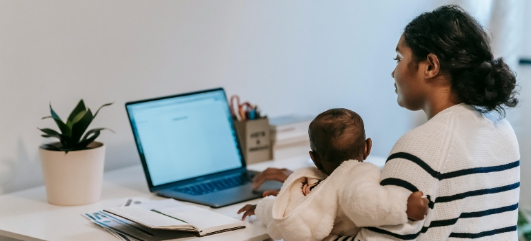 A woman with a baby working from home.