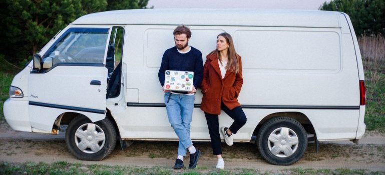 Couple moving in the fall and holding packed boxes