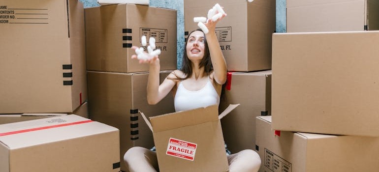 A woman surrounded by moving boxes