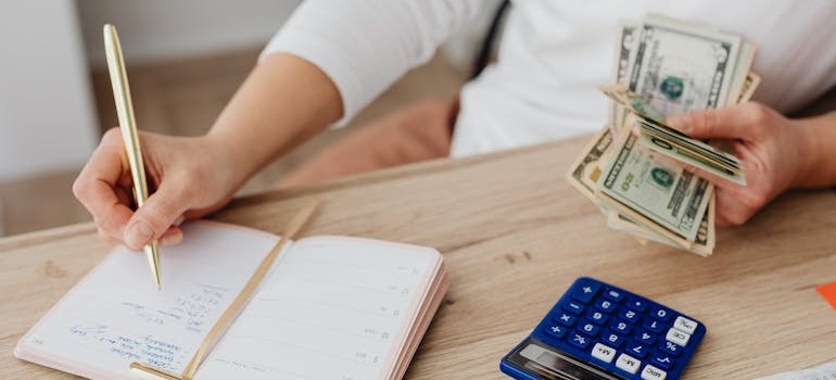 A person trying to create a moving budget and stick to it