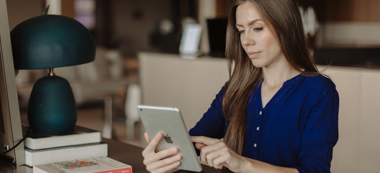 A woman doing research on her tablet