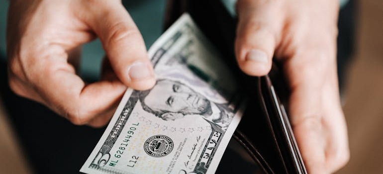 A person taking money out of a wallet
