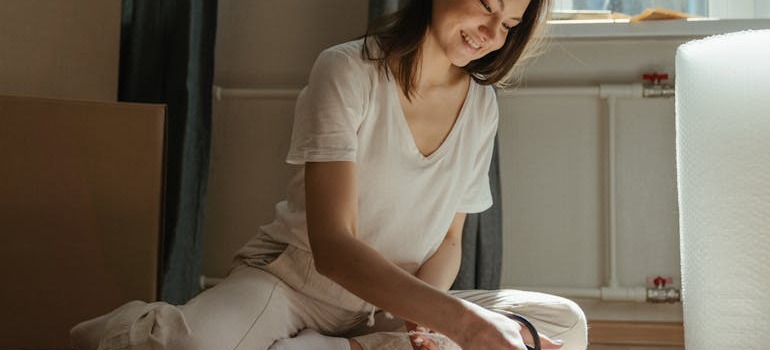 A woman preparing to pack up belongings for storage