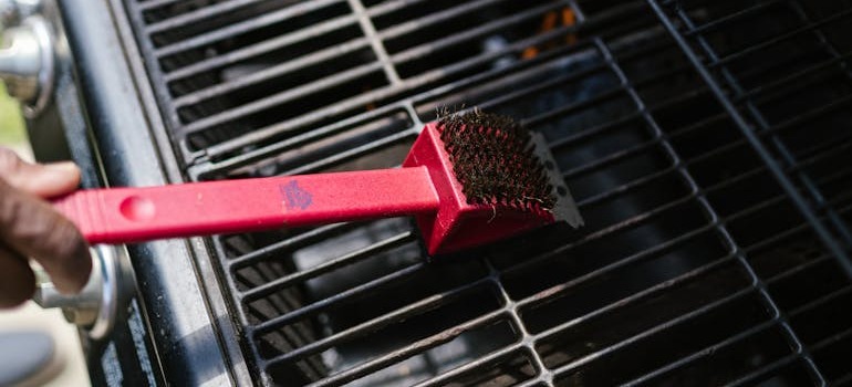 A person cleaning before trying to store outdoor equipment like grills and lawn tools in Ottawa