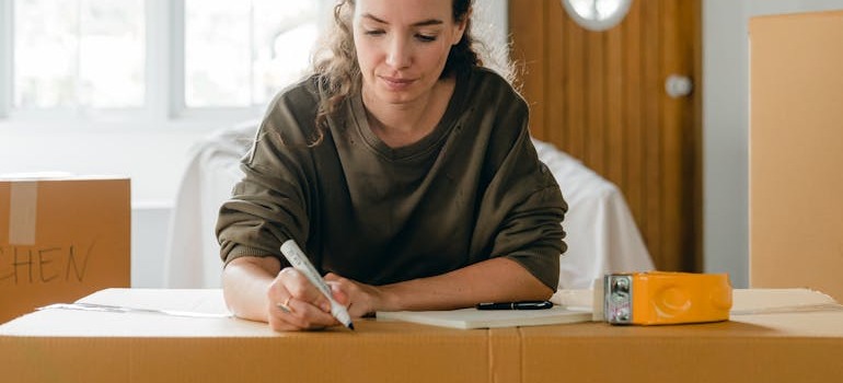 A woman making labels when she wants to store outdoor equipment like grills and lawn tools in Ottawa