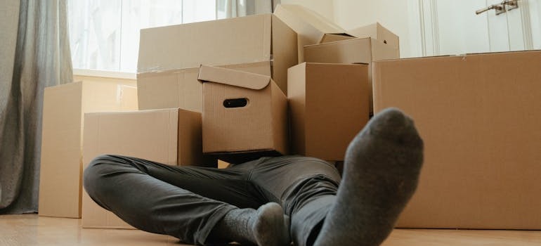 A man under moving boxes