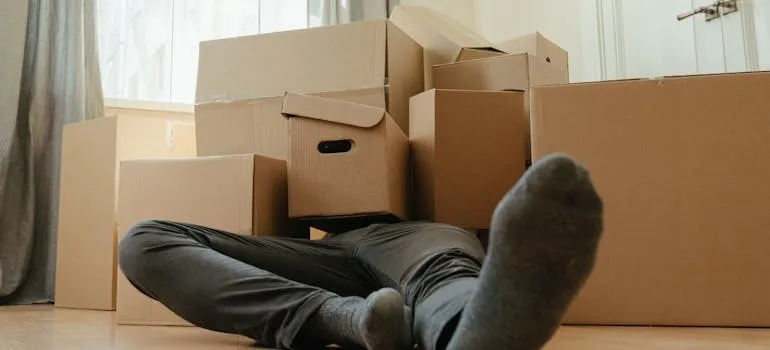 A man under moving boxes