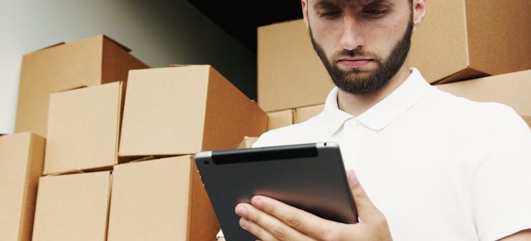 A man going over how to label and organize moving boxes for storage in Ottawa