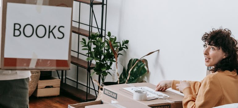 A couple preparing boxes for storage