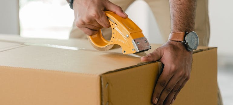 A man closing a box