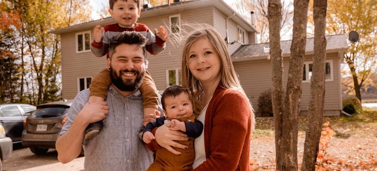 A happy family in front of their home