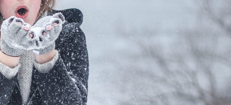 A woman blowing snow