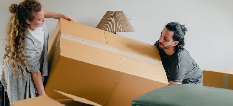 A couple moving a large box