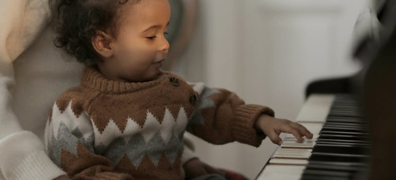 A mother and her child playing a piano