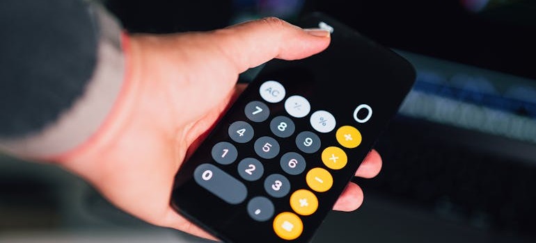 A person using the caculator after find the most affordable moving solutions in Ottawa